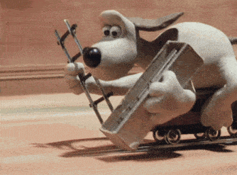 Wallace and Gromit laying railway track in front of a moving train.